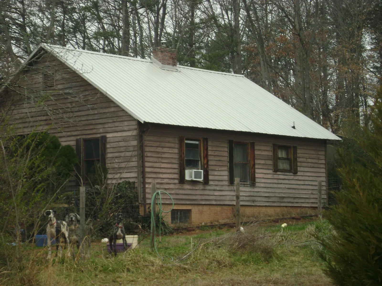 White metal roof on an old wood sided farmhouse, from a Metal Roof Installation job in Antrim